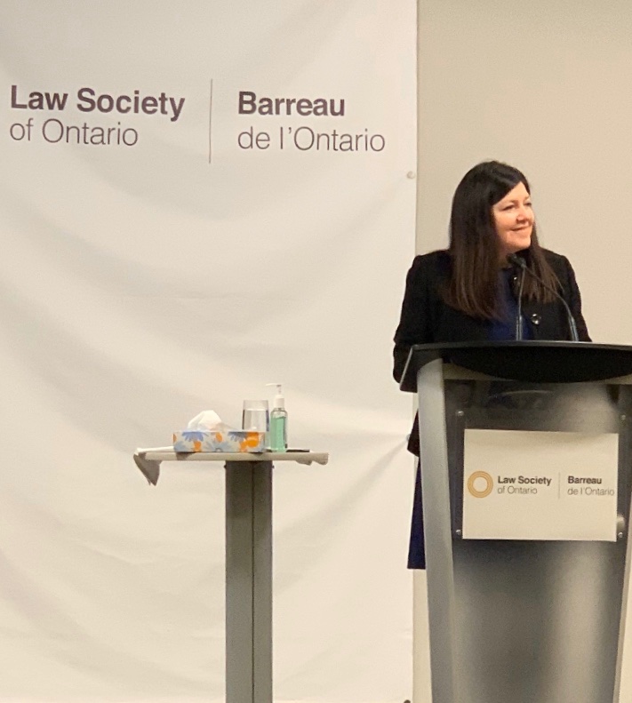 Kim Stanton is standing at a podium delivering a speech for the Law Society of Ontario